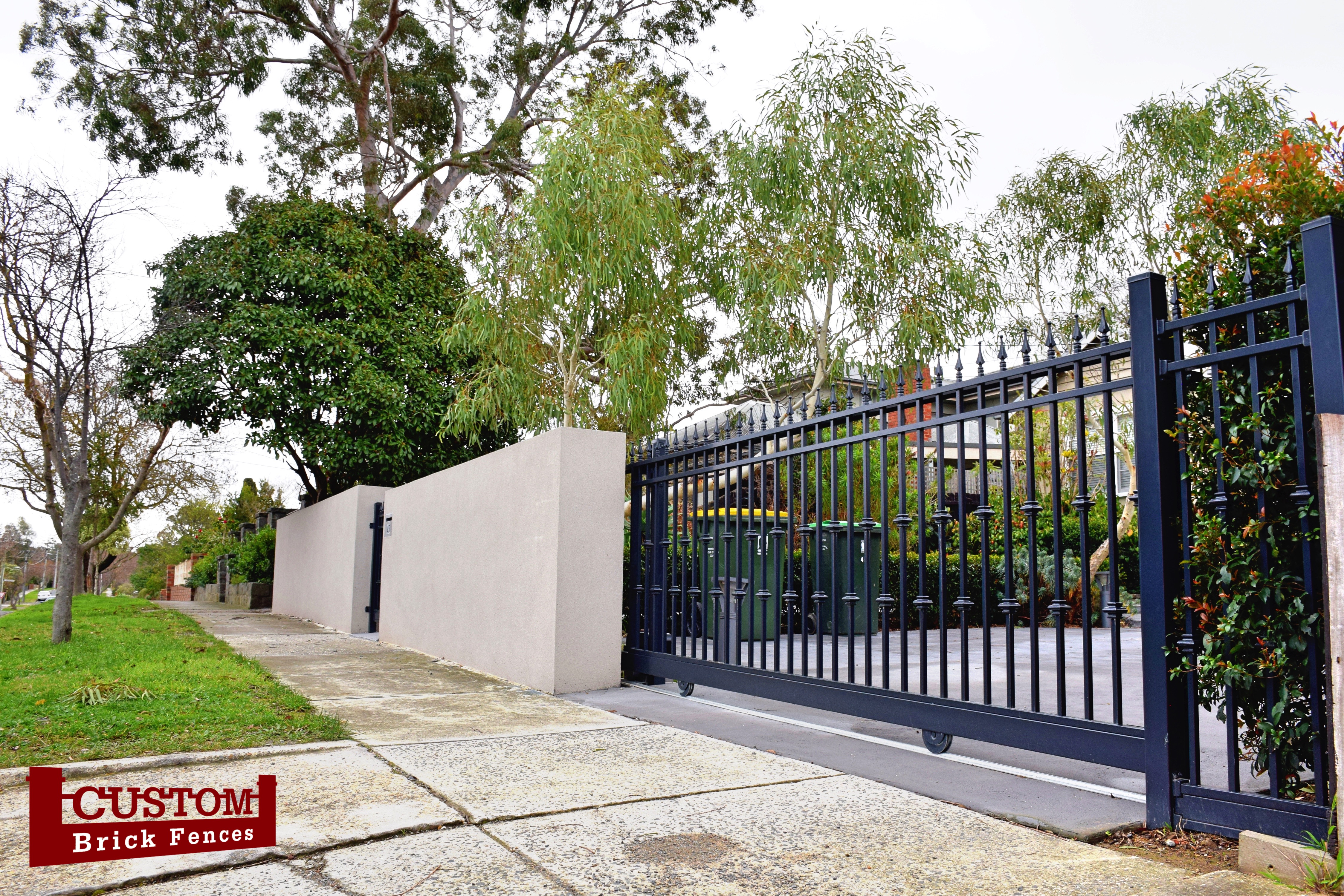 Custom Built Fences Rendered wall fence with large steel sliding gate