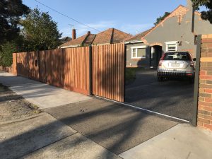Merbau Slat fence with powder coated steel posts and frame designed and built by Custom Built Fences