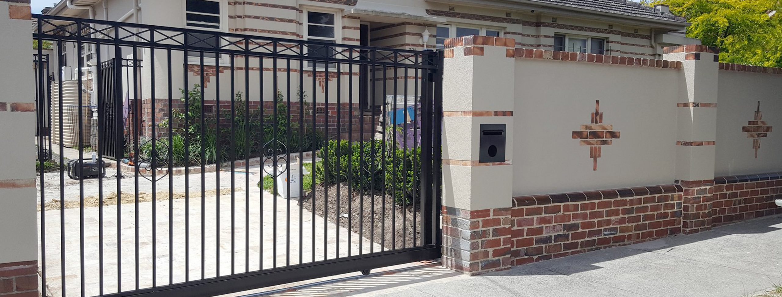 Combination Brick fence with steel sliding gate designed and built by Custom Built Fences