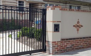 Brick Combination fence with steel driveway gate designed and built by Custom Built Fences