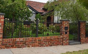 Red Brick fence with steel infills designed and built by Custom Built Fences