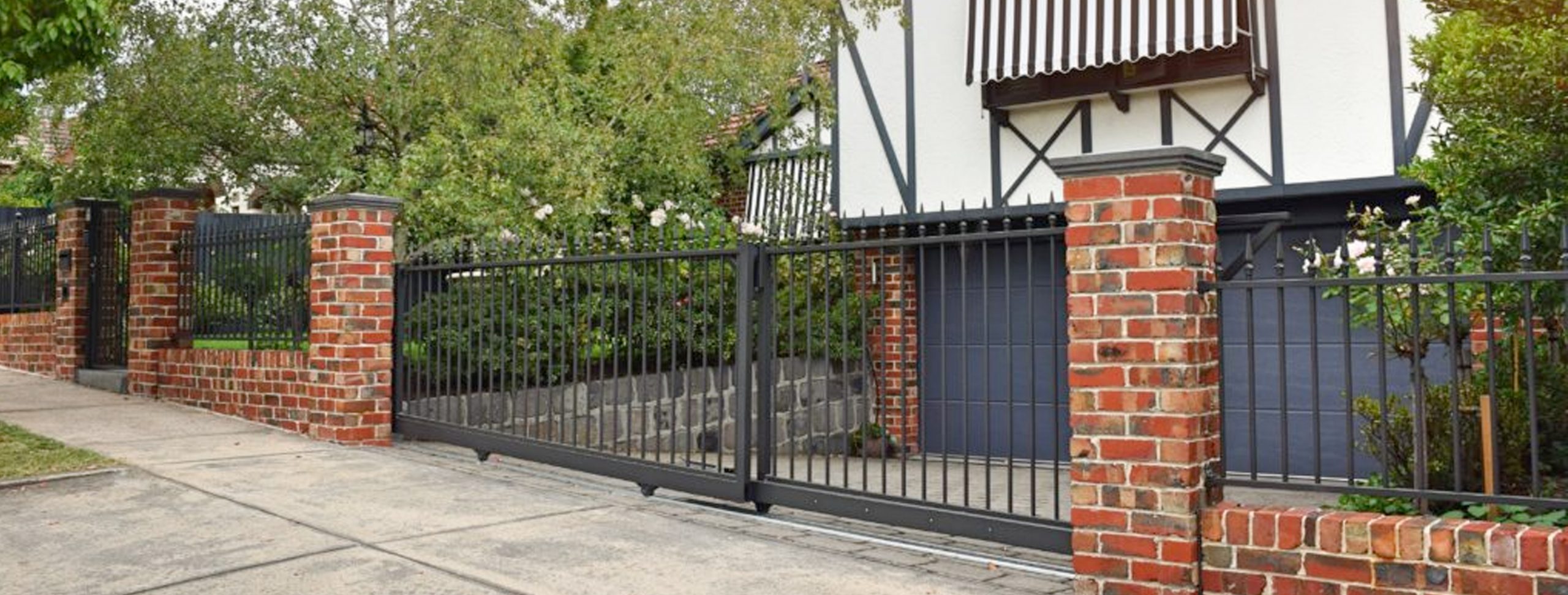 Red Brick Pillars with steel spear infills designed and built by Custom Built Fences